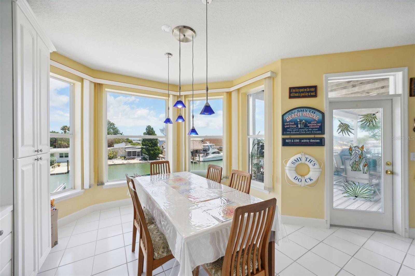 dining area with bay windows and water views