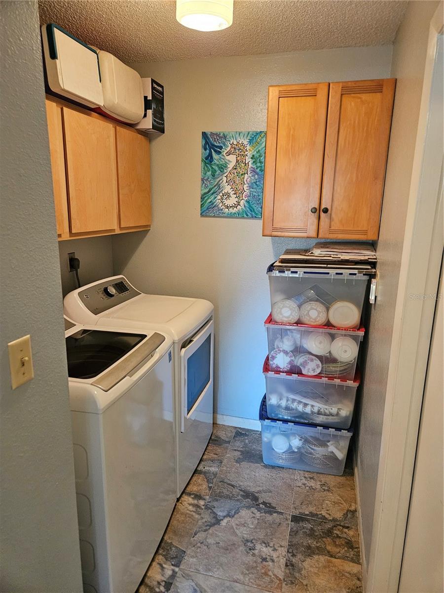 Laundry Room off Kitchen with built in cabinets and a door to the 2 Car Garage