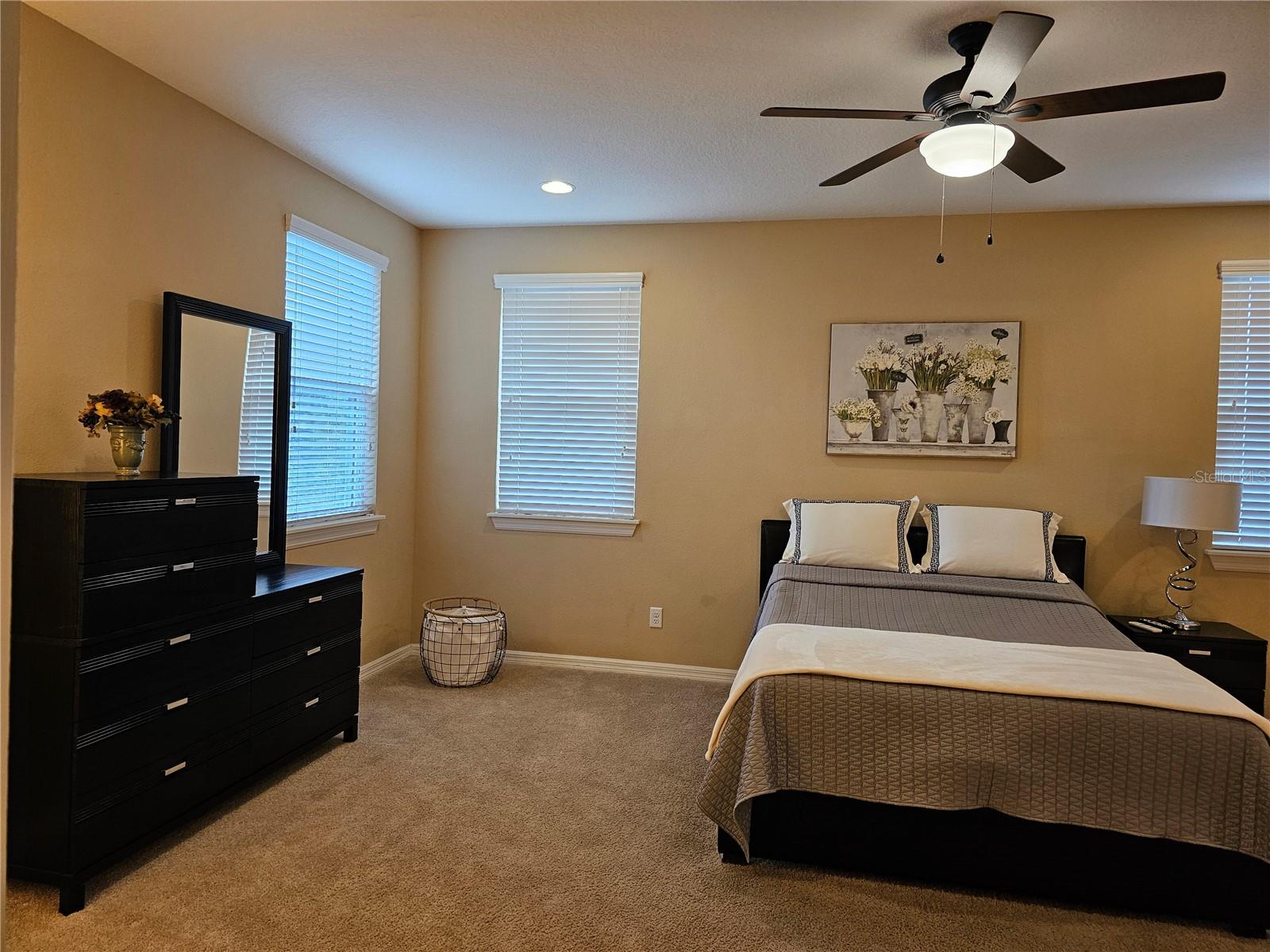 The spacious primary bedroom features a large walk-in closet offering plenty of storage space and room for personal touches.