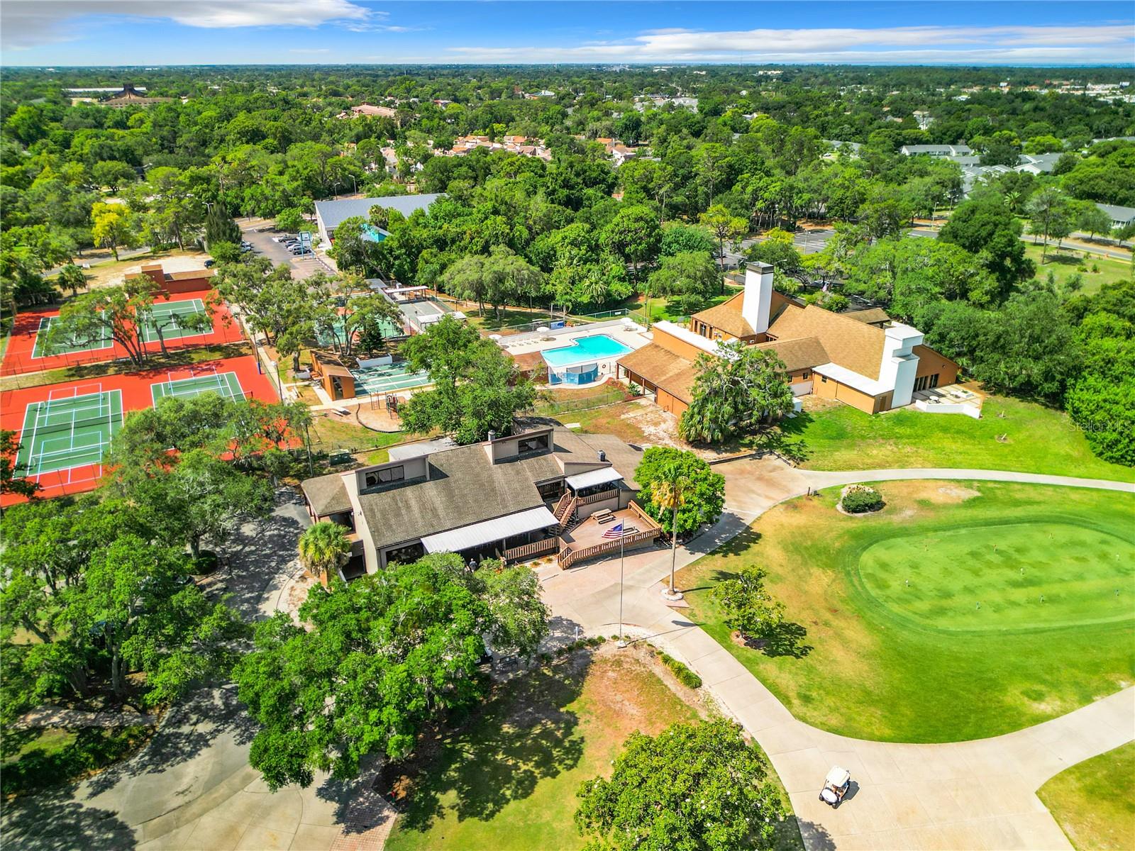 Public golf course foreground, community amenities in rear