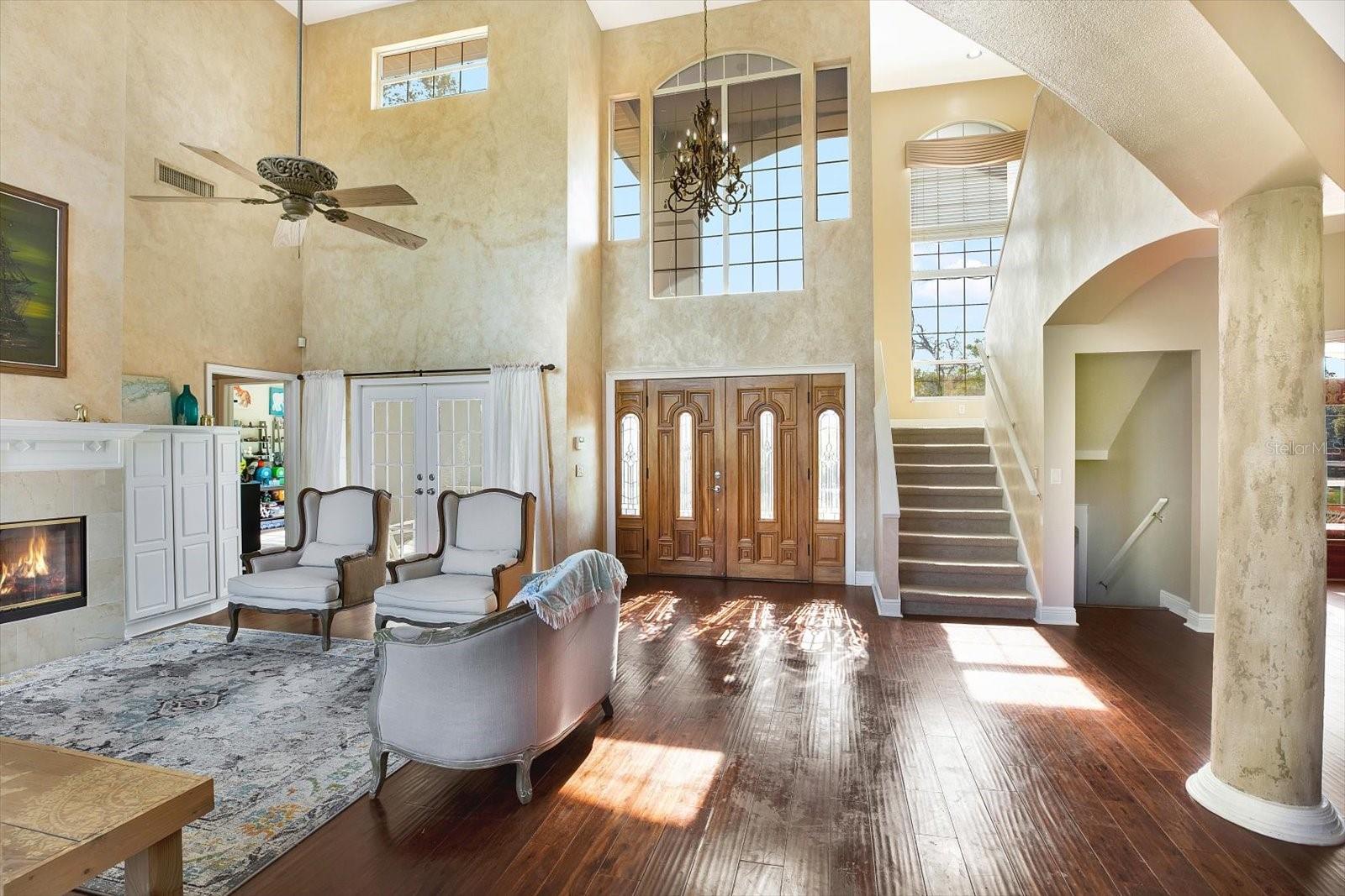 An open floor plan greets you at the door with windows and ceiling height galore