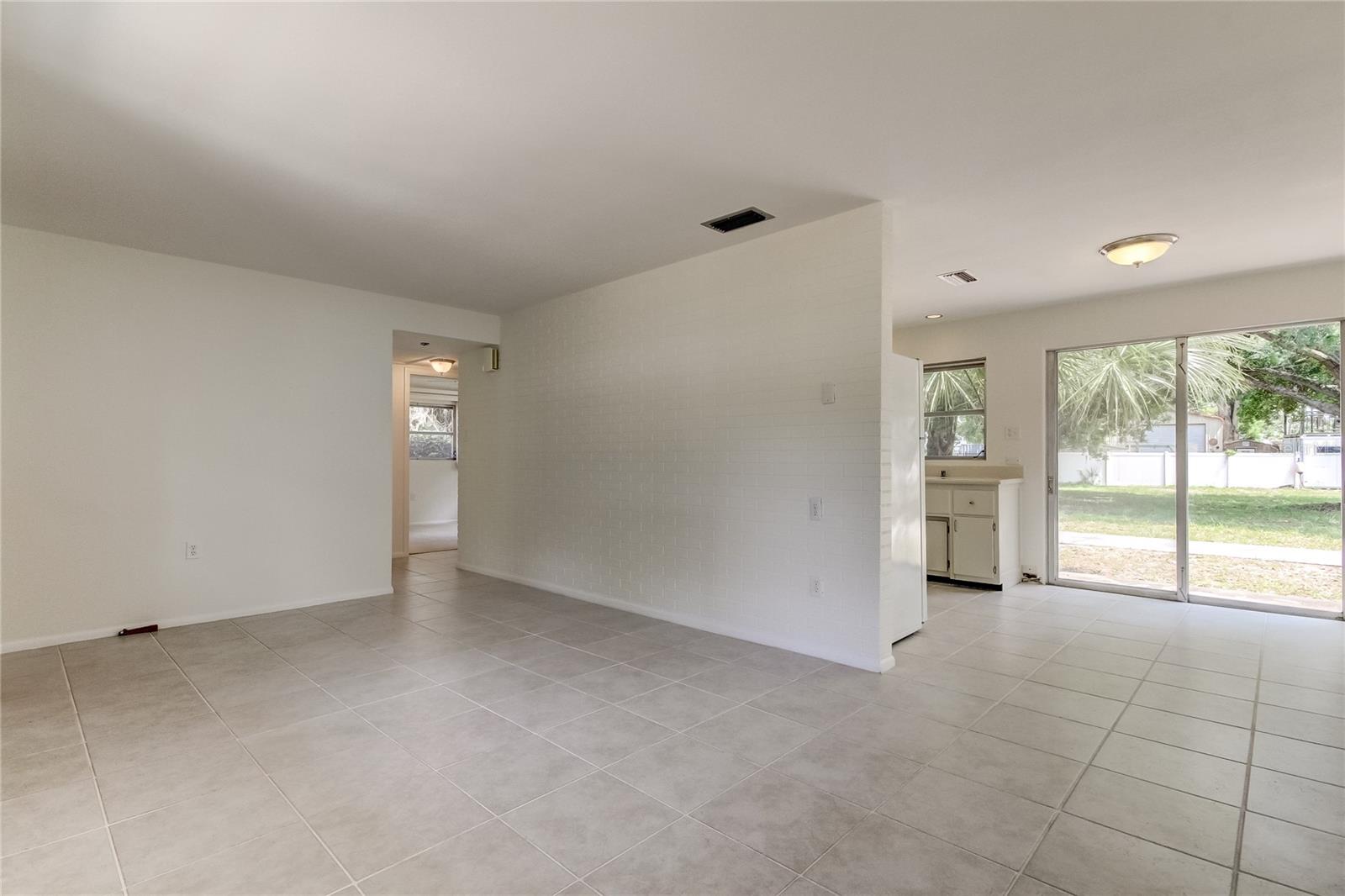 View from front entrance room into dining area and kitchen