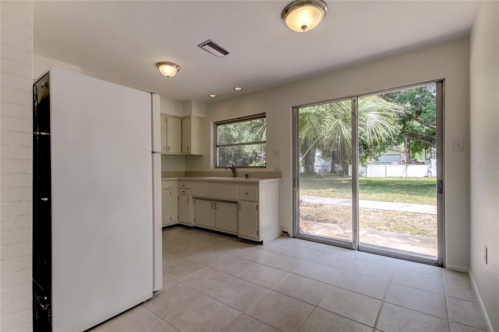 View from front entrance room into dining area and kitchen