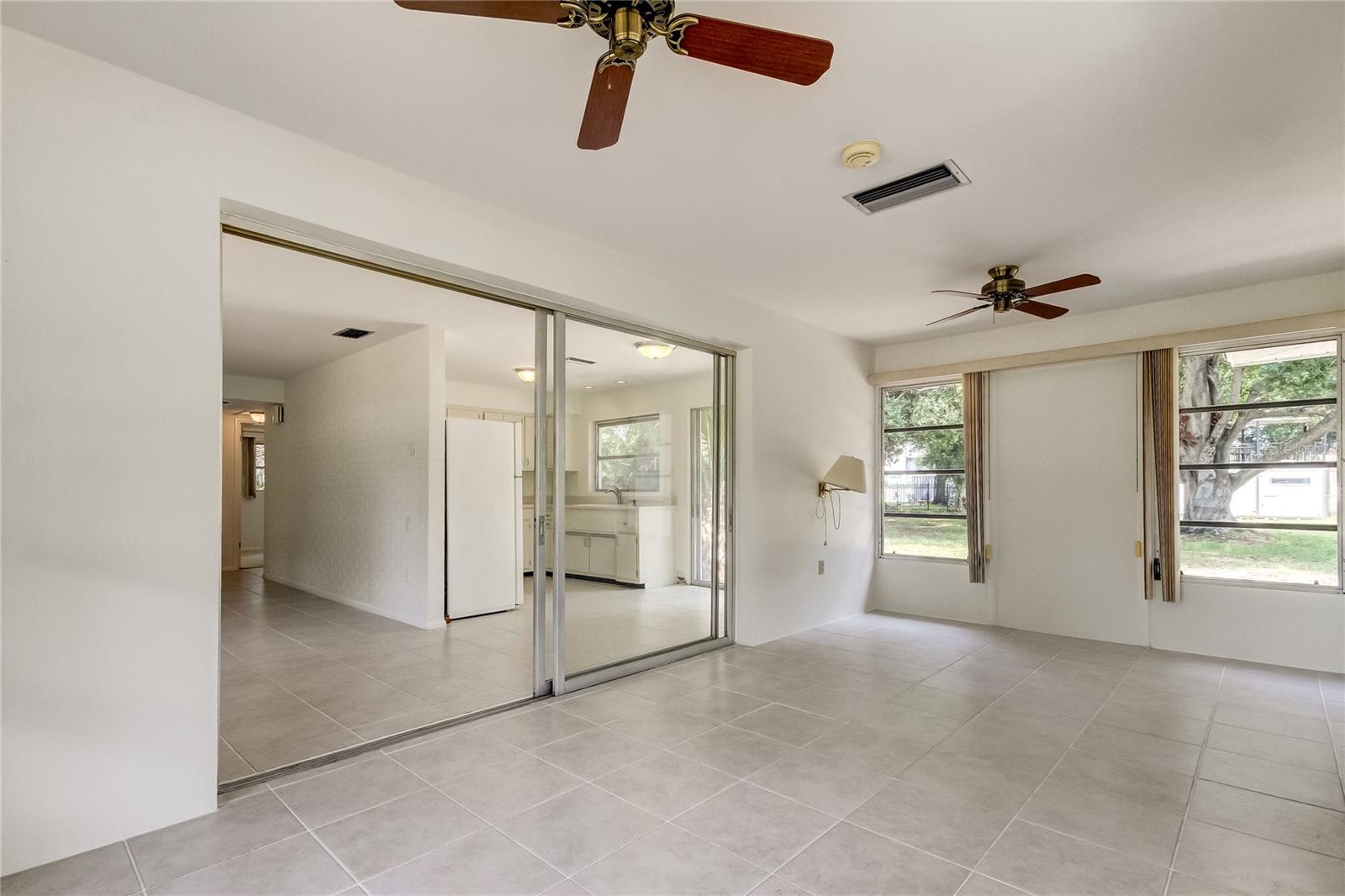 View from sun room / bonus room looking into back yard and kitchen / dining room