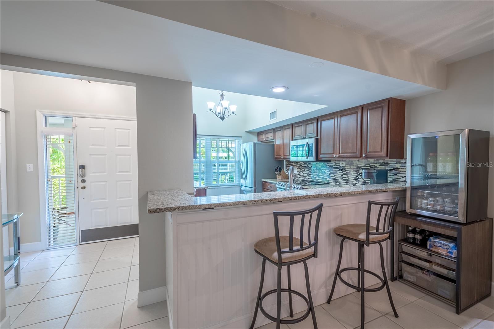 The kitchen features a breakfast bar that comfortably seats three.