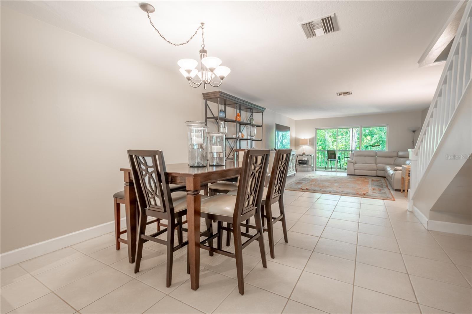 The 9 x 10 dining room features a ceramic tile floor and chandelier.