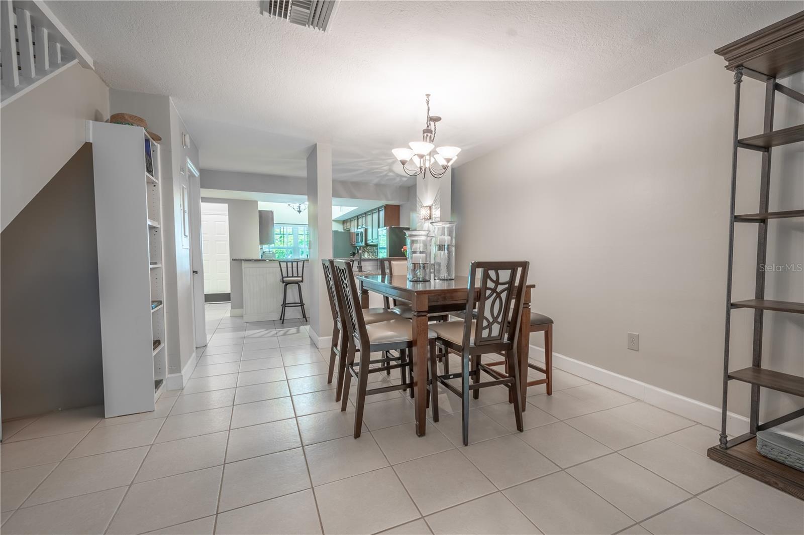 The dining room is situated between the kitchen and living room.