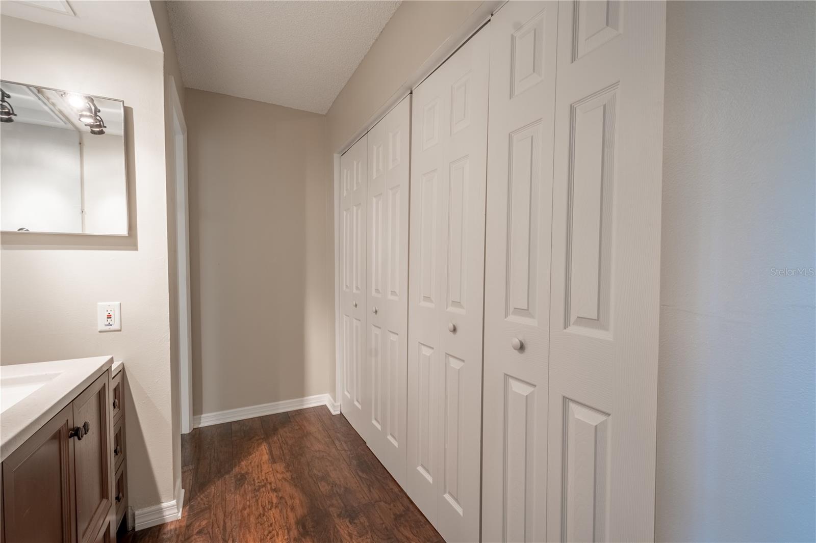 The primary bath features vinyl (wood plank) flooring