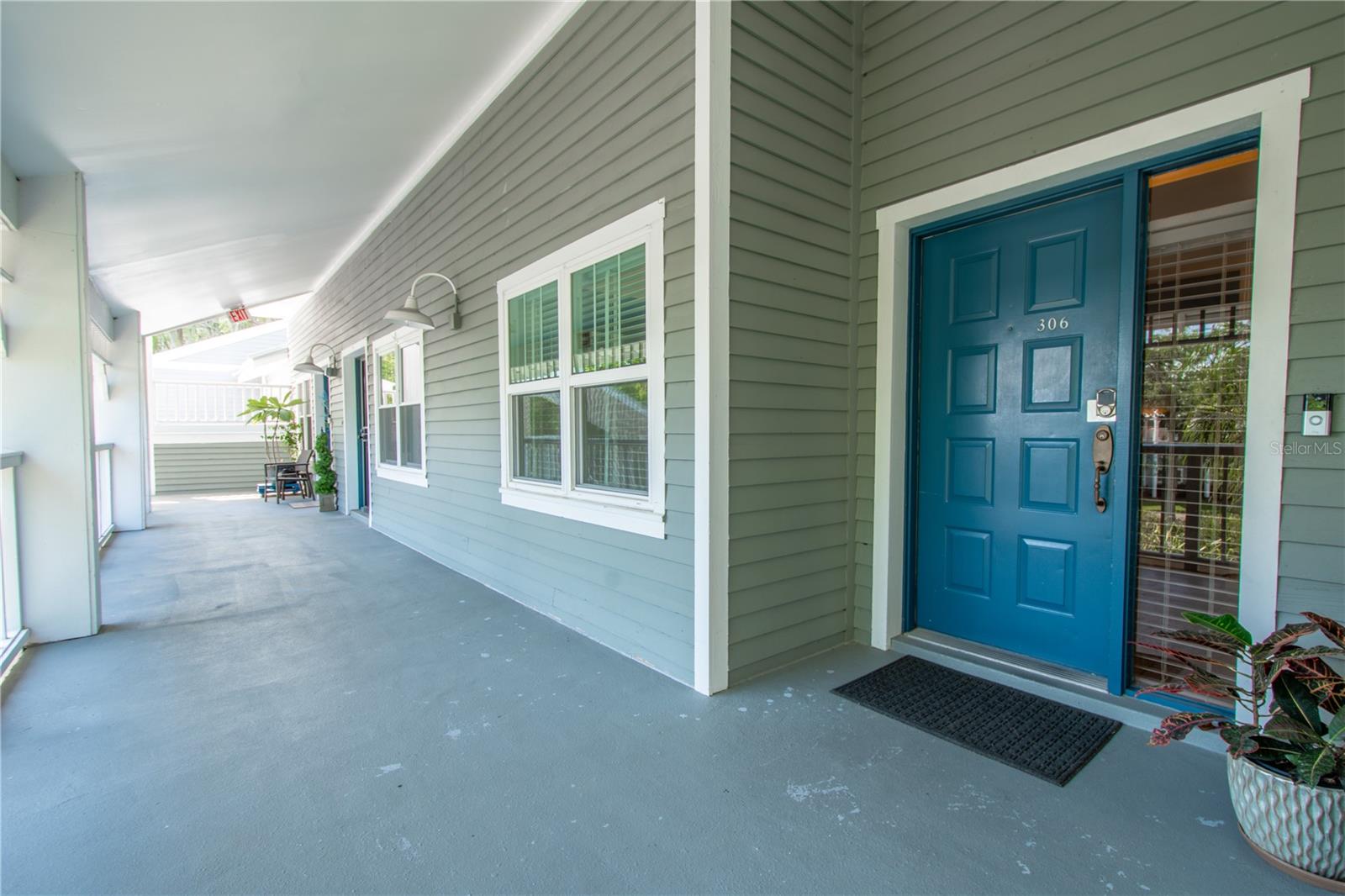 Large well lit covered entryway to front door.