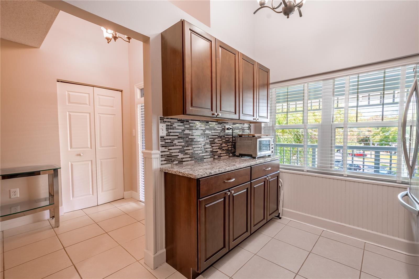 The kitchen's wood cabinetry provides plenty of storage.