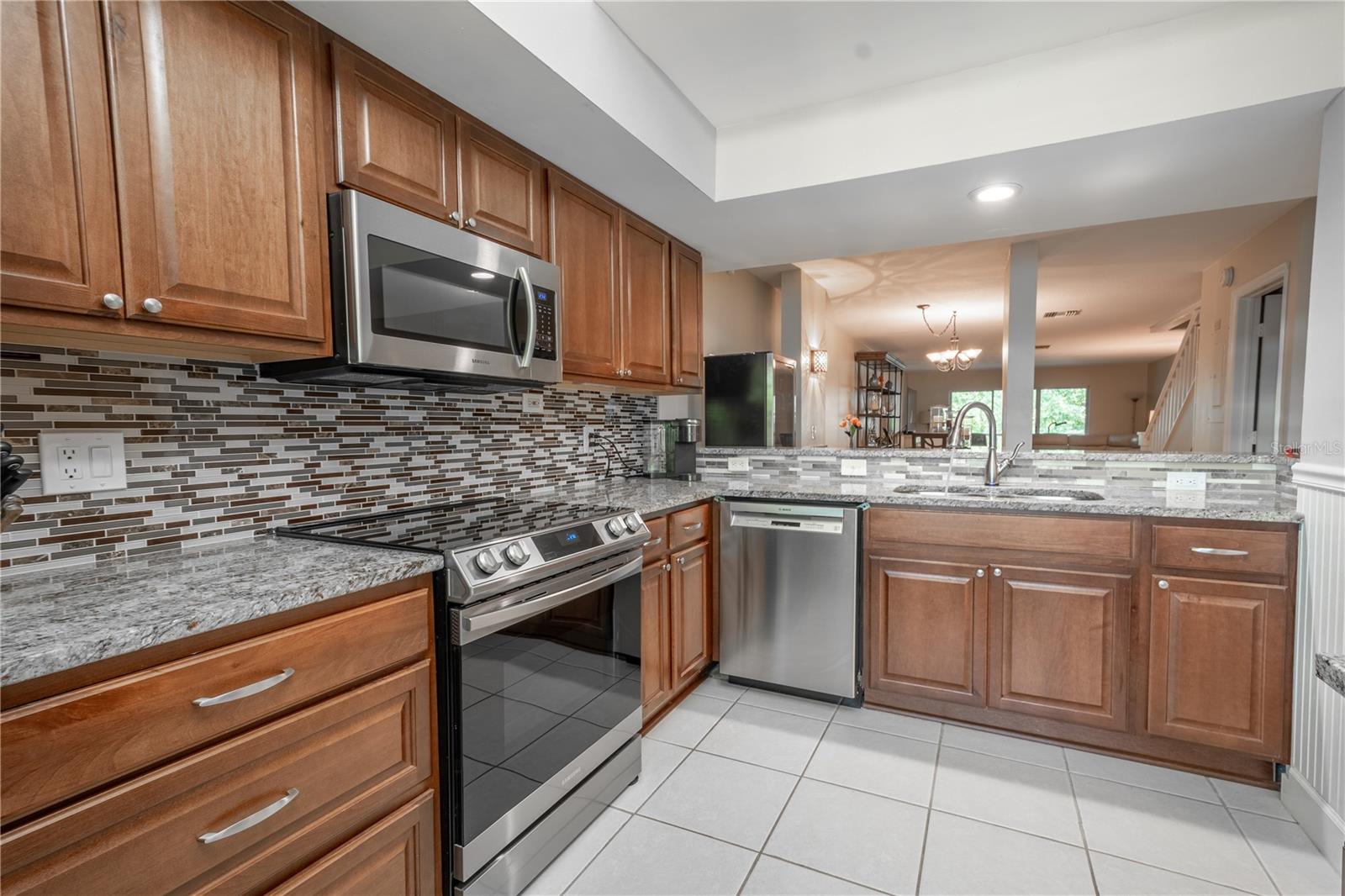 The kitchen is equipped with a full suite of stainless steel appliances.