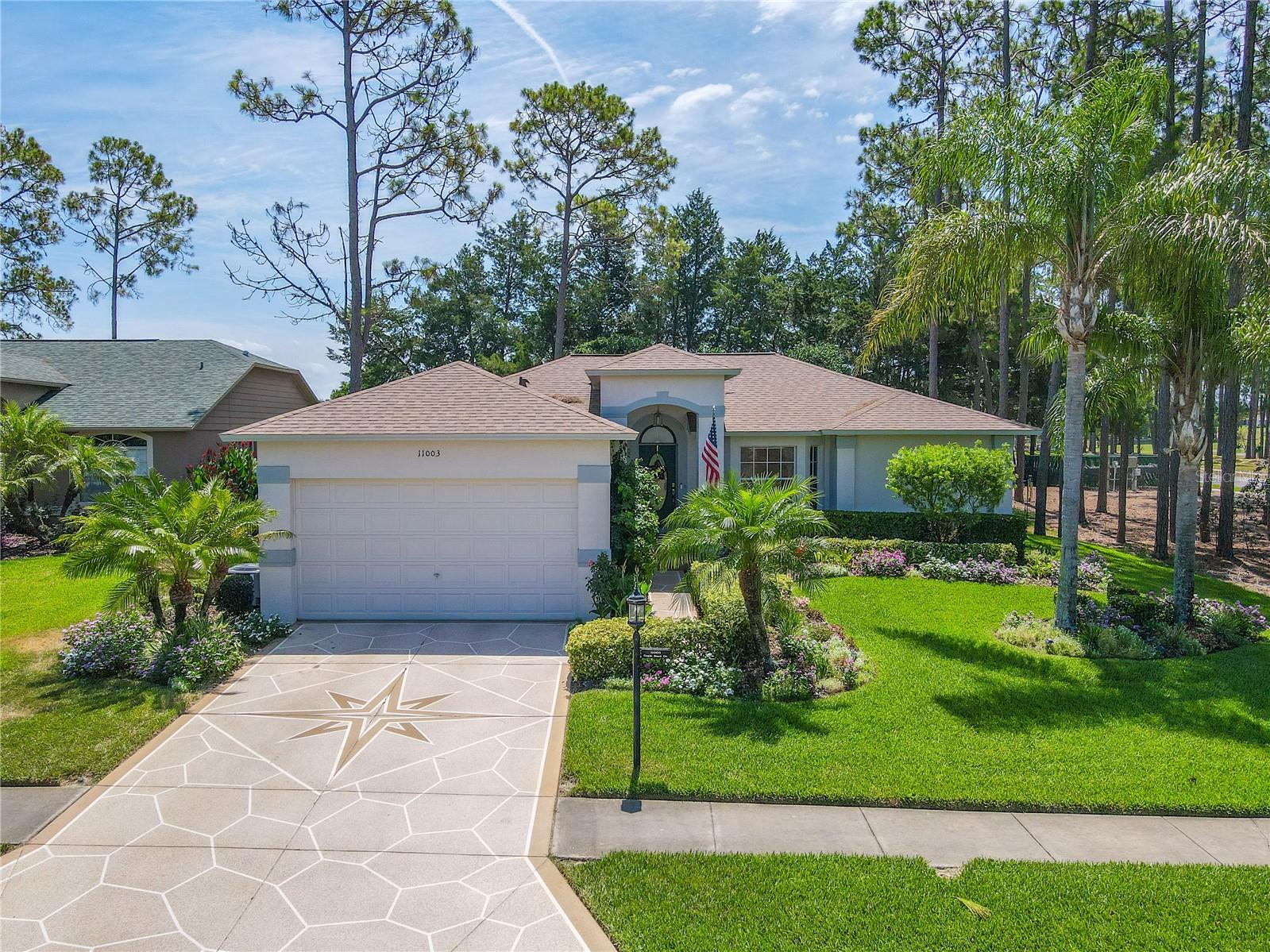 Curb appeal resounds with meticulously manicured grounds and a statement driveway.