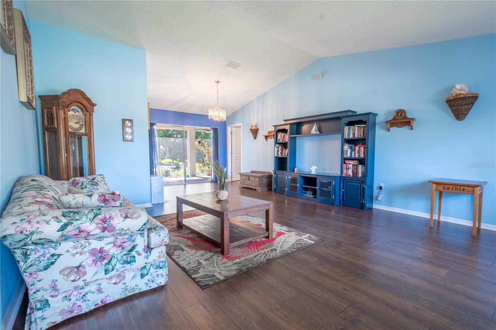 Vaulted ceilings and luxury vinyl floors create a light and air feel in the living room.