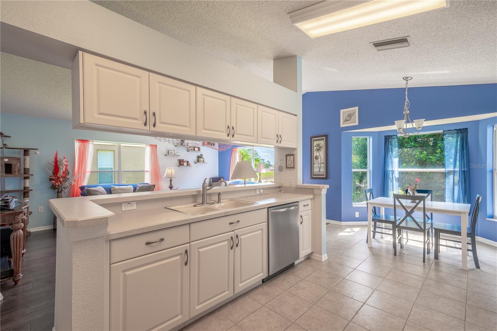 The kitchen features ceramic tile flooring and overhead lighting.