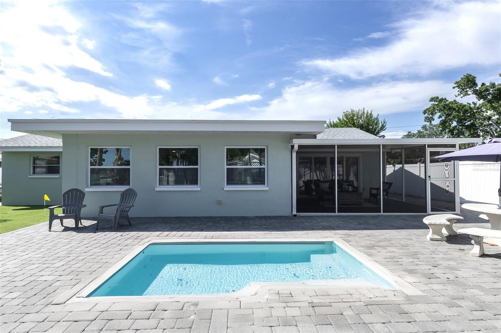 This is virtually staged pool in the backyard