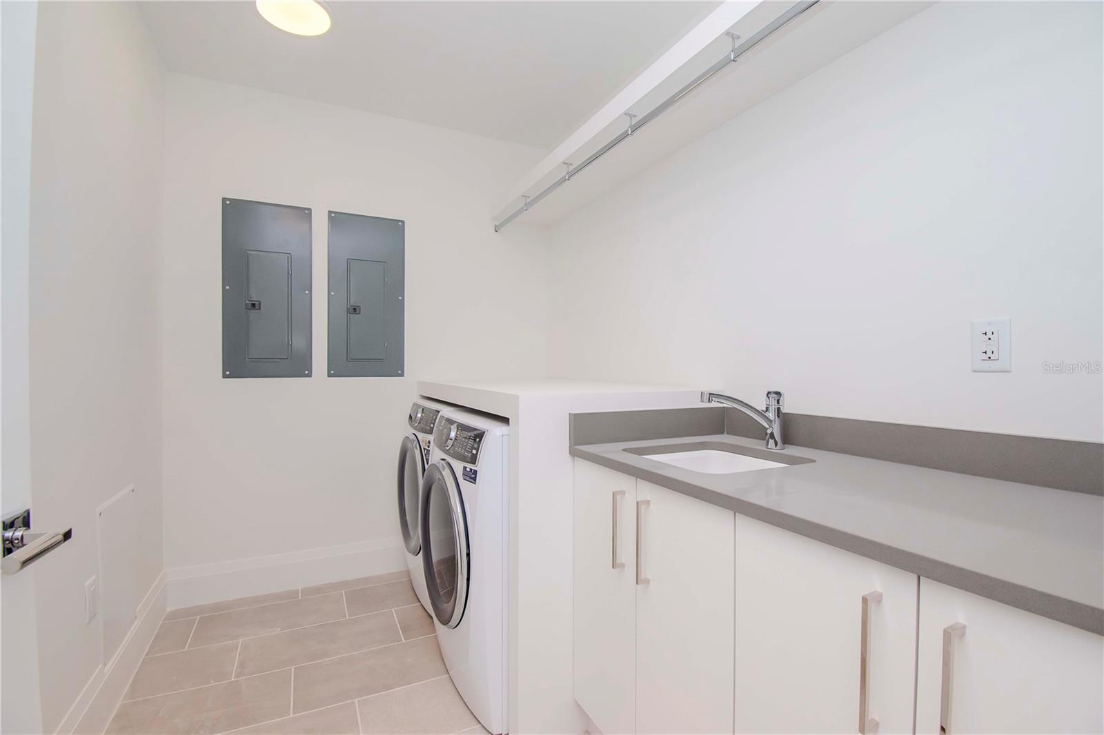 Laundry with expanded cabinets and countertops