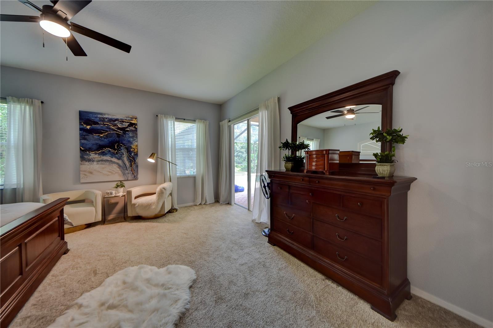 Primary Bedroom W/ Sliders Leading To Pool/ Lanai and Pool Bathroom