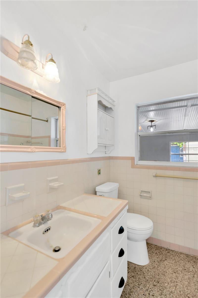 Main home bathroom has its original 50s charm with a facelift