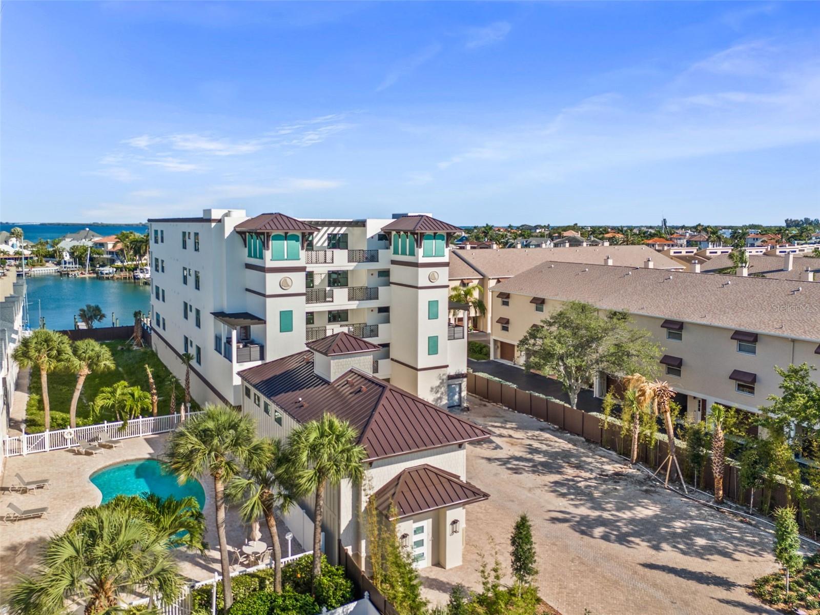 Water views from every residence at Quiet Cove. Every residence is considered a corner unit. You can see here the Carriage house, which is where a fitness center will be, and the individual climate-controlled storage units....