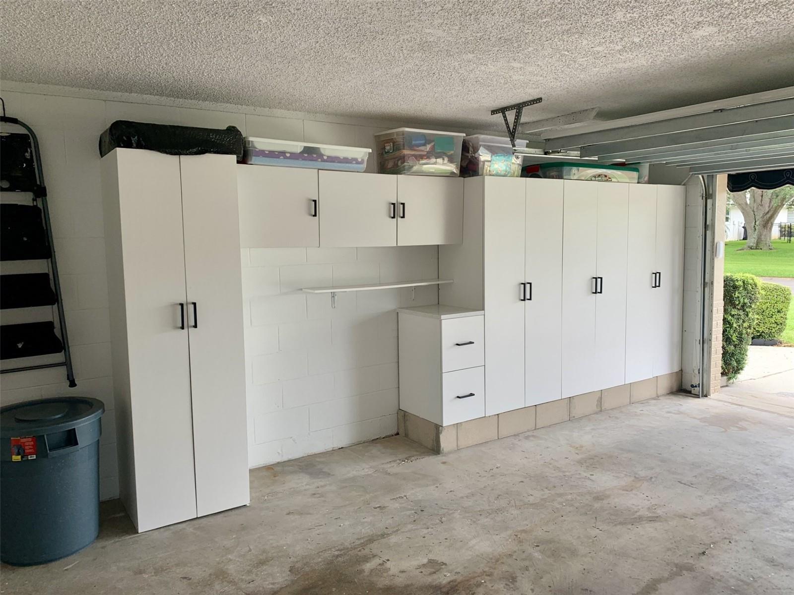 2 car garage interior wiith built-in storage shelves.