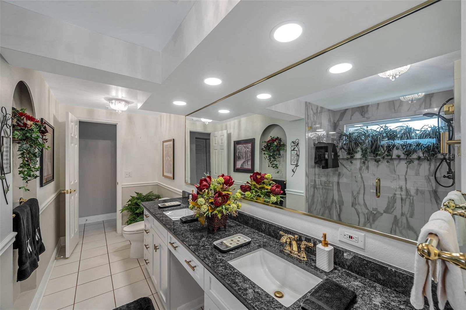 Guest bathroom with shower  reflection in mirror.