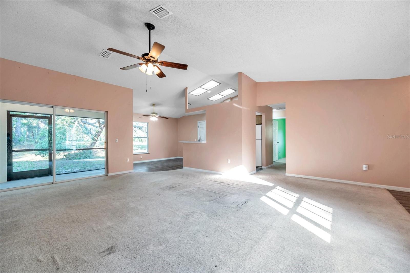 Oversized sliding glass doors leading to Screened Lanai