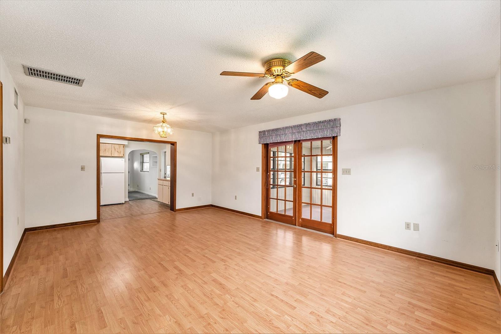 Family room with double doors leading to the Florida room