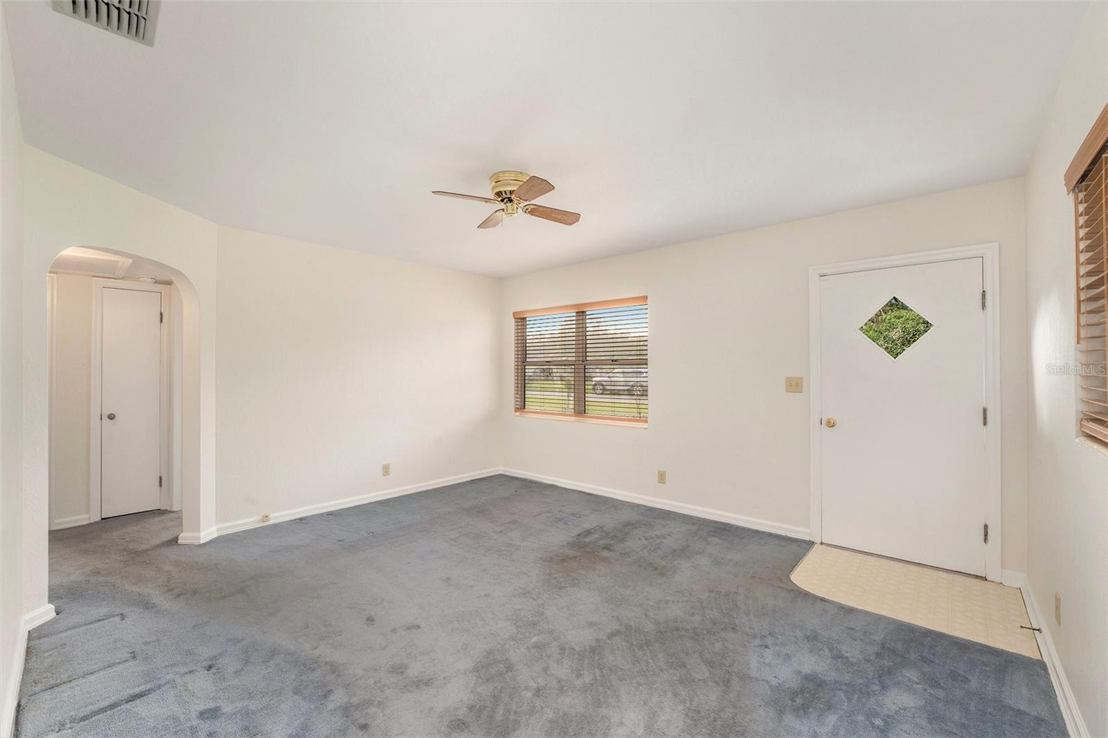 Livingroom with front door entry and locking glass door