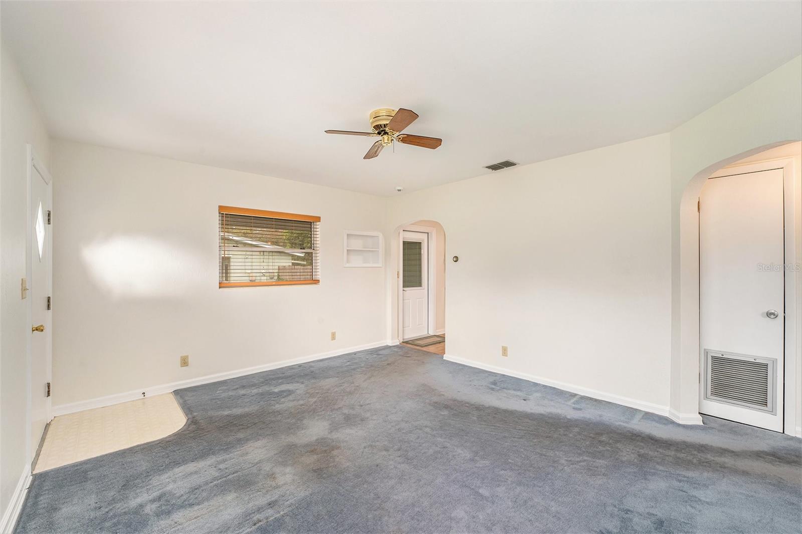 Livingroom with window overlooking the carport