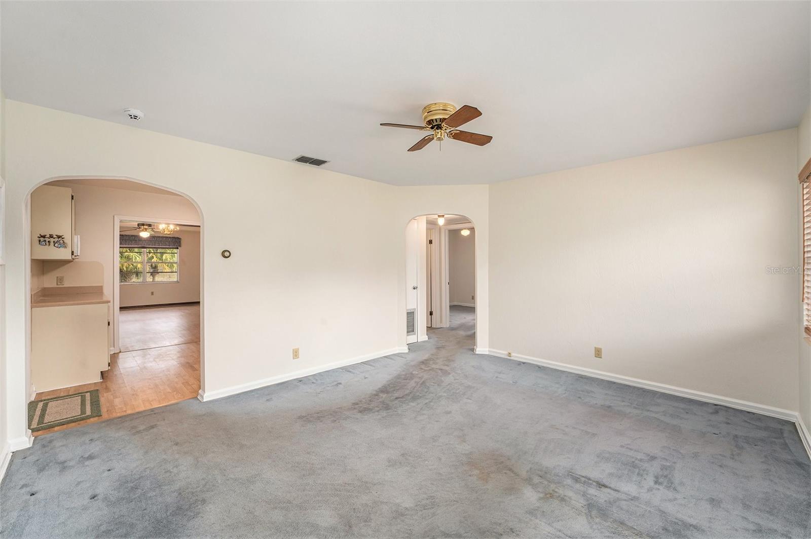 Livingroom with archway leading to the kitchen