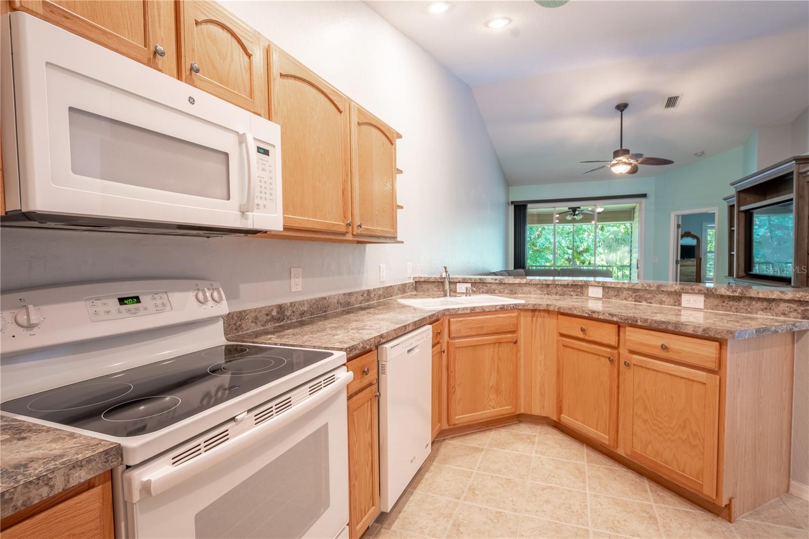 The kitchen features recessed lighting.