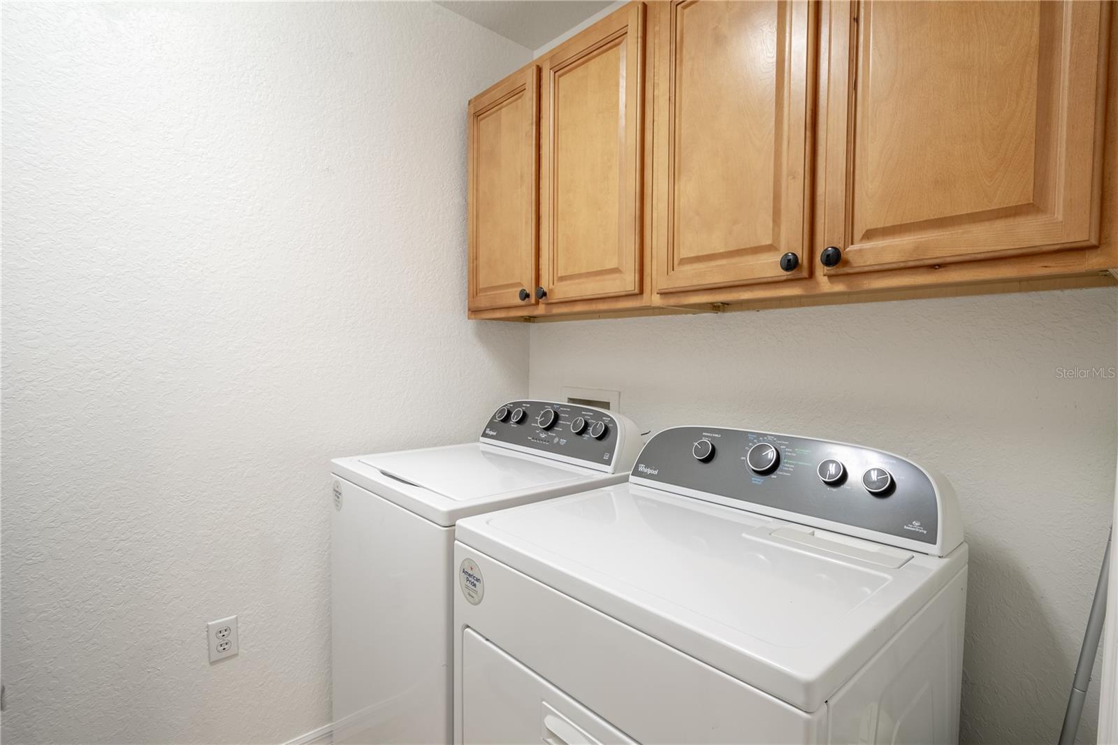 The laundry room is equipped with hook-ups for YOUR washer dryer. It also features wood cabinets for additional storage.