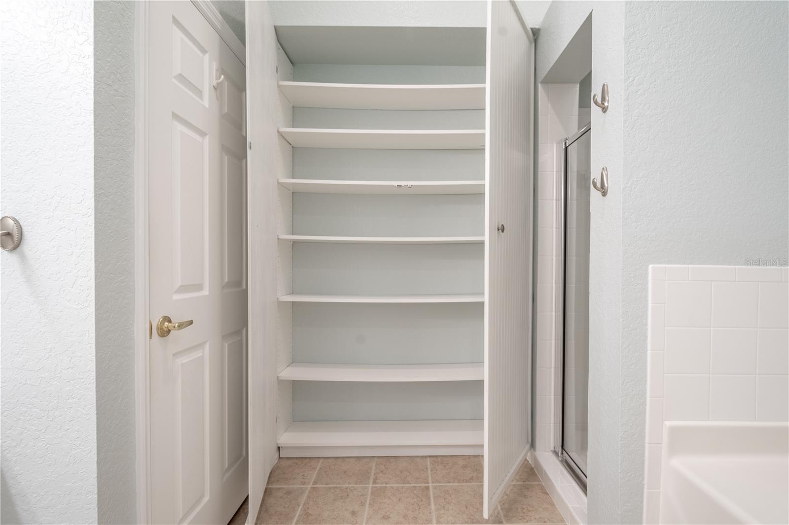 The primary ensuite bath features a floor to ceiling linen closet.