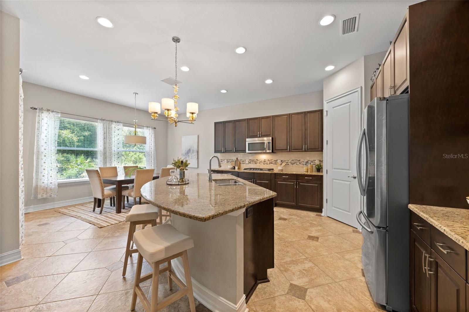 Full view of kitchen with overflow eating area