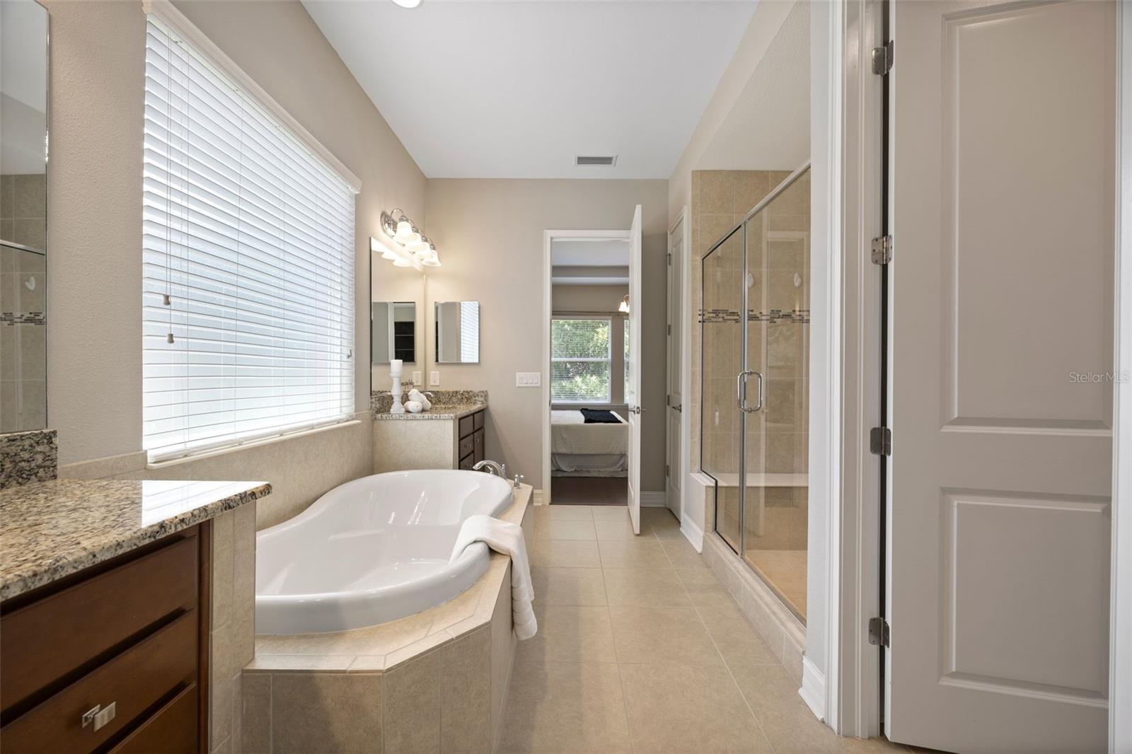 Full view of the bathroom with water closet in a separate closed in area