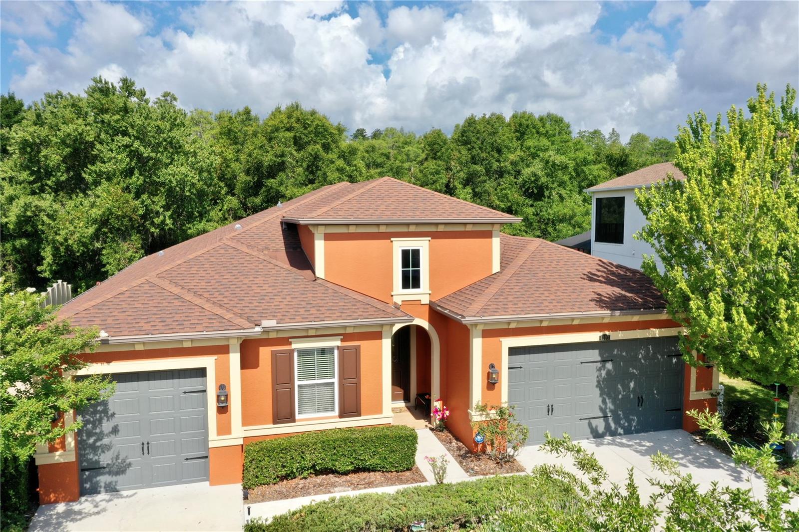 Side view of home with three car garage