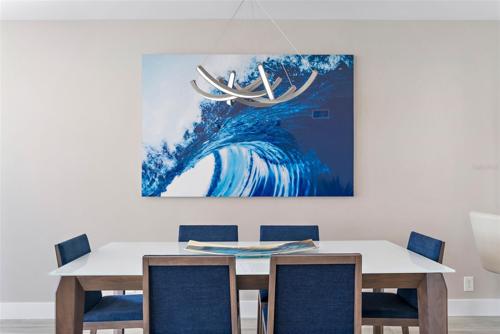 Dining area highlighted by custom coastal art