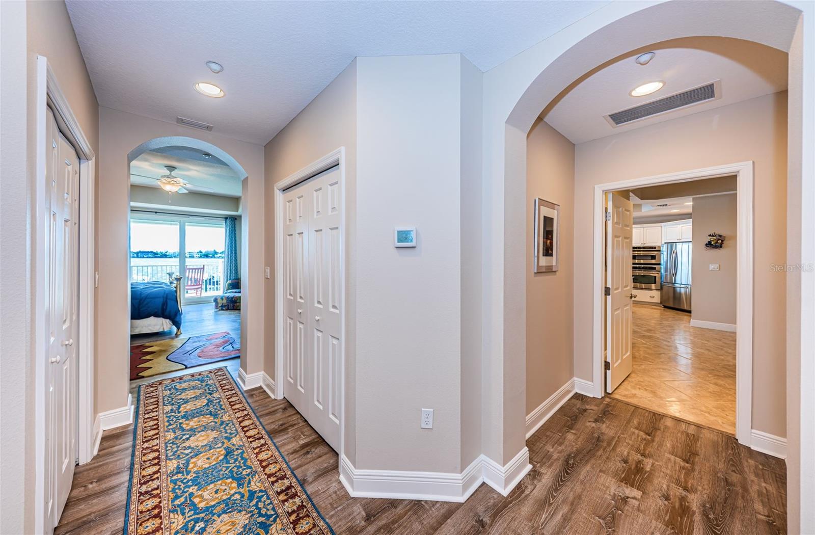 ... Split Hallway Shot with Master Bedroom on Left and Hallway To Kitchen on Right.