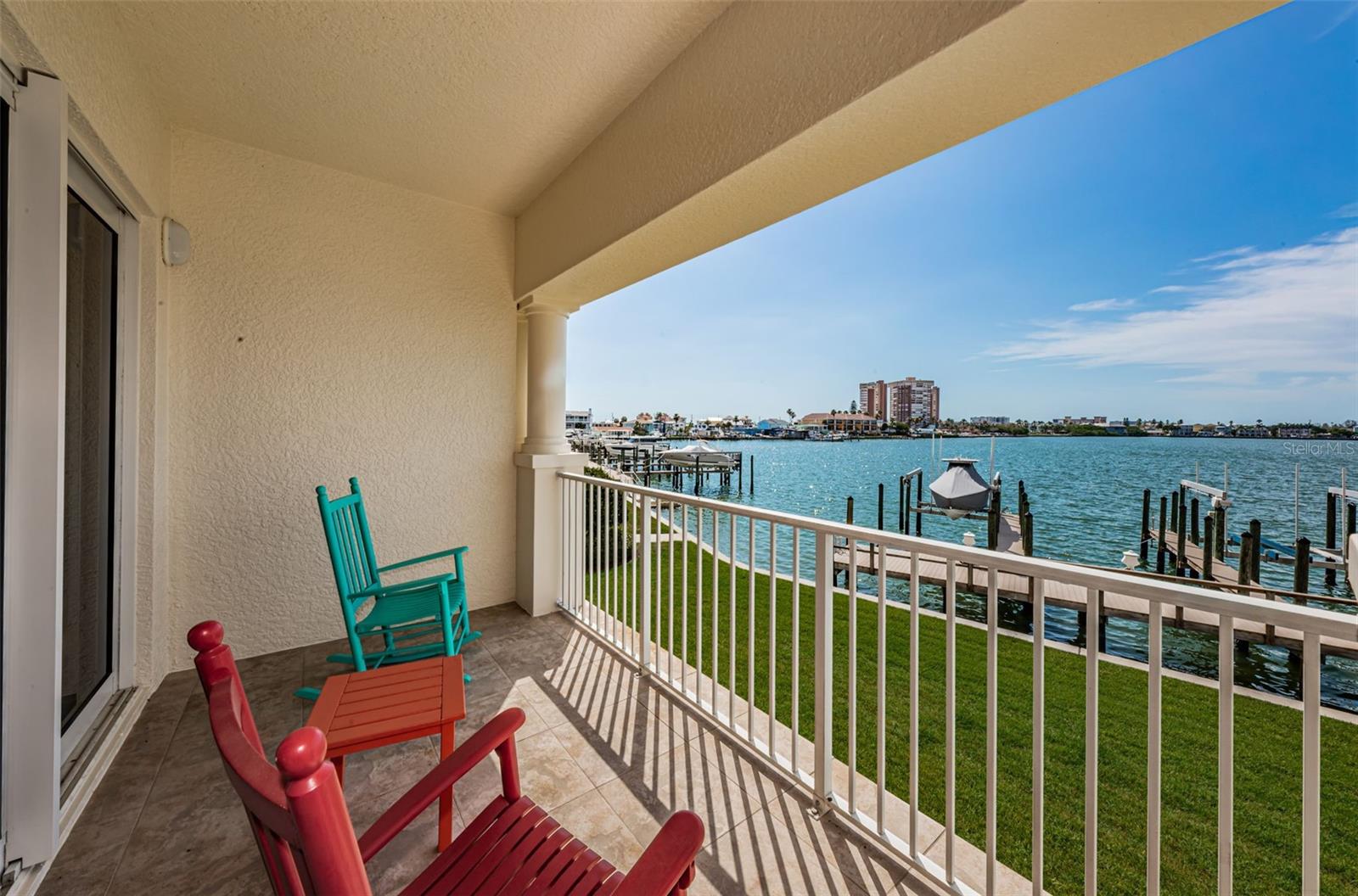 . Sweeping Water Views Over Boca Ciega Bay from Master Bedroom Balcony Area. This 45 Foot Waterfront Balcony runs along the entire Unit. View Looking West. Balcony Sliders Lead to Master Bedroom Suite.