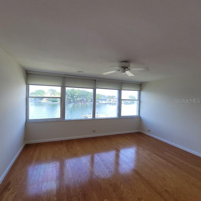 The 14X15 Primary Bedroom also has beautiful views of the Bay! There are blinds on these windows and huirricane shutters.