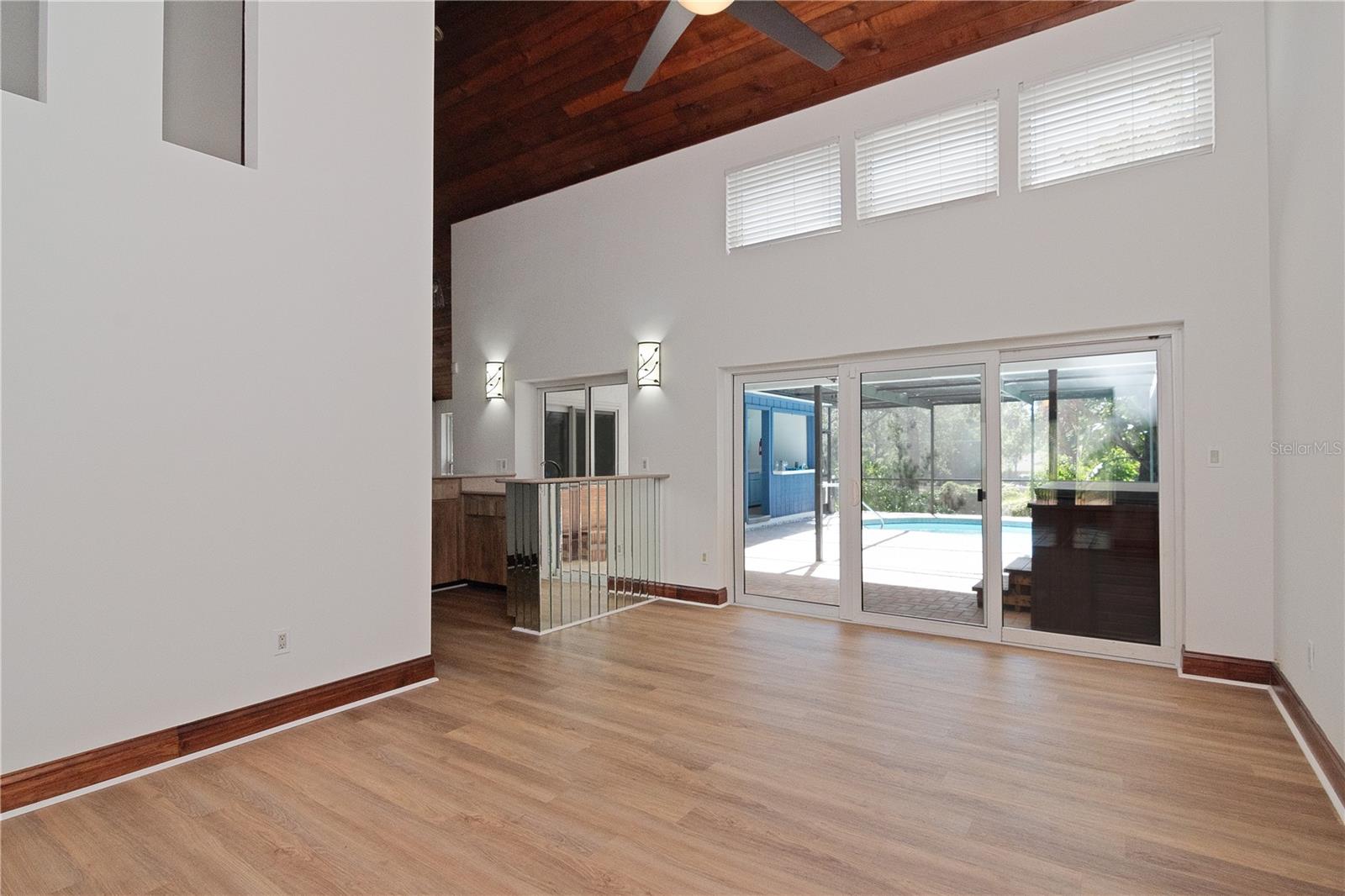 Living Room featuring New Lighted Ceiling Fan, New Paint, Vaulted Ceilings and New Vinyl Flooring