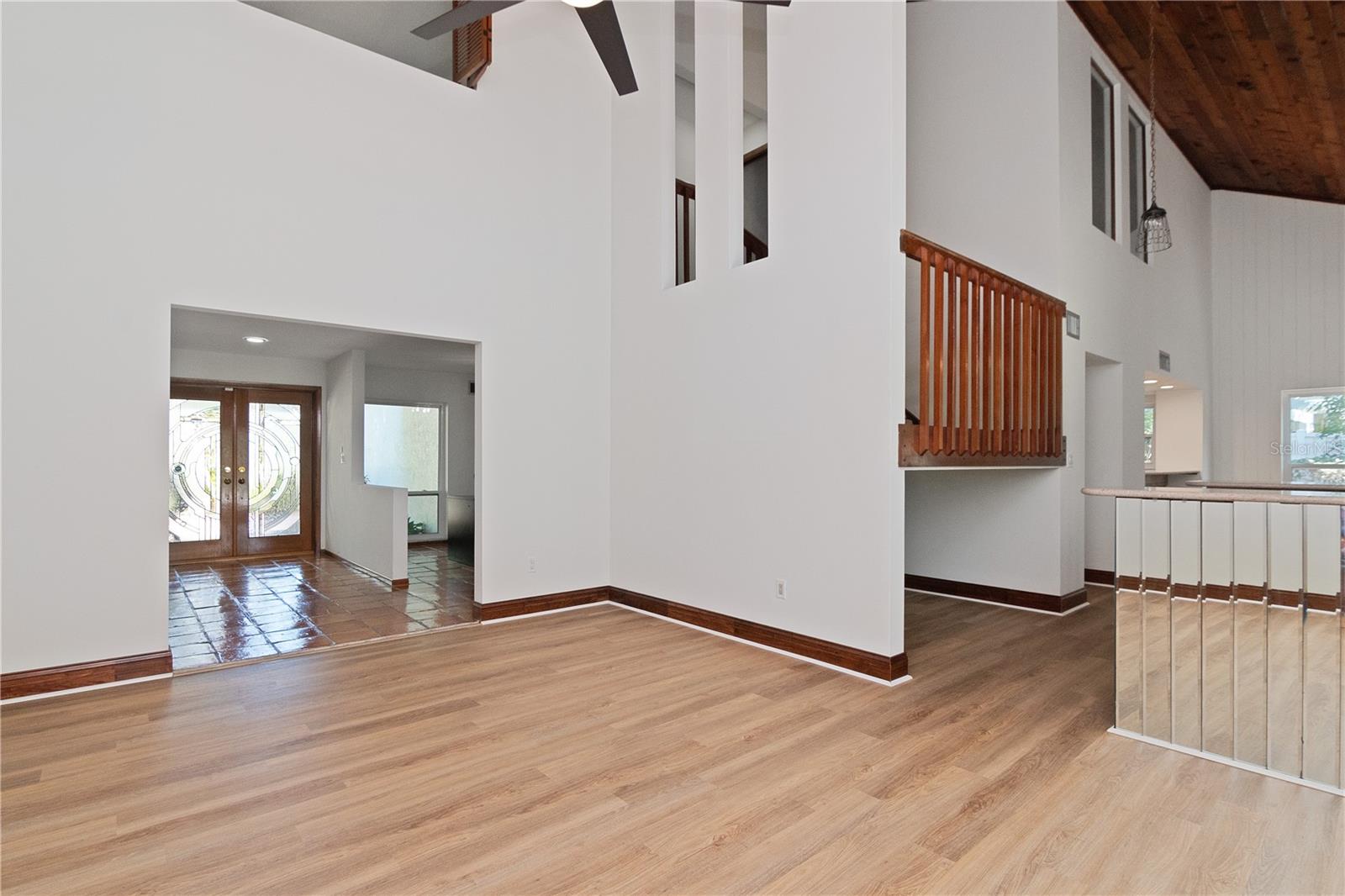 Living Room featuring New Lighted Ceiling Fan, New Paint, Vaulted Ceilings and New Vinyl Flooring