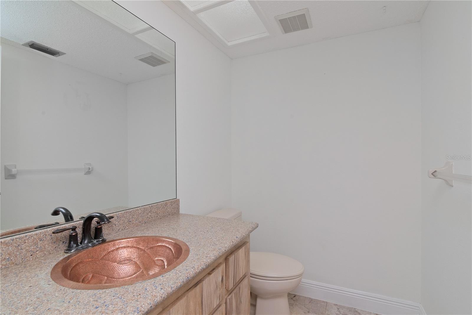 Downstairs half-bath featuring New Paint, with Copper Sink, Quartz Countertops and Tile Floor