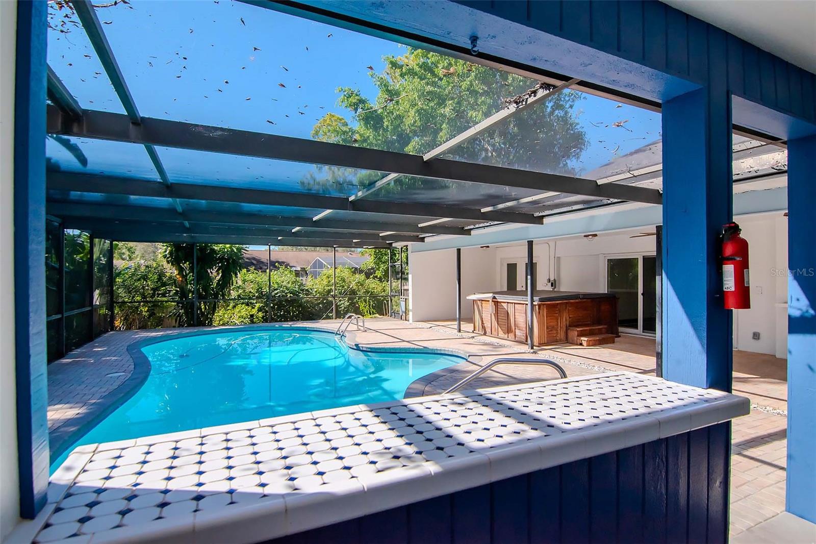 View of Pool and Hot Tub from Outdoor Kitchen and Bar with Tile Countertops