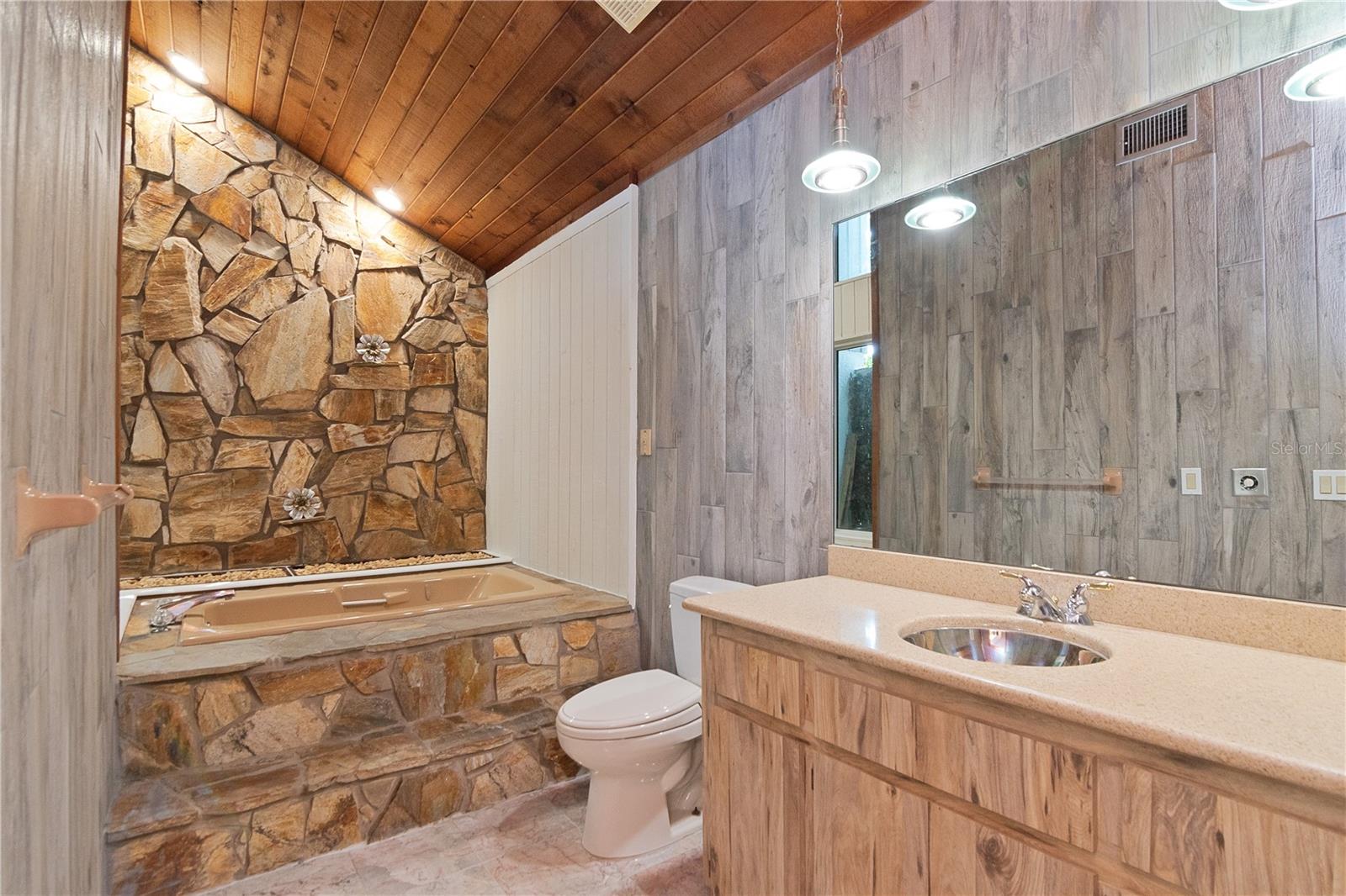 Primary Ensuite Bathroom with Garden Tub, Vanity with Quartz Countertops and Tile Floor featuring New Paint.