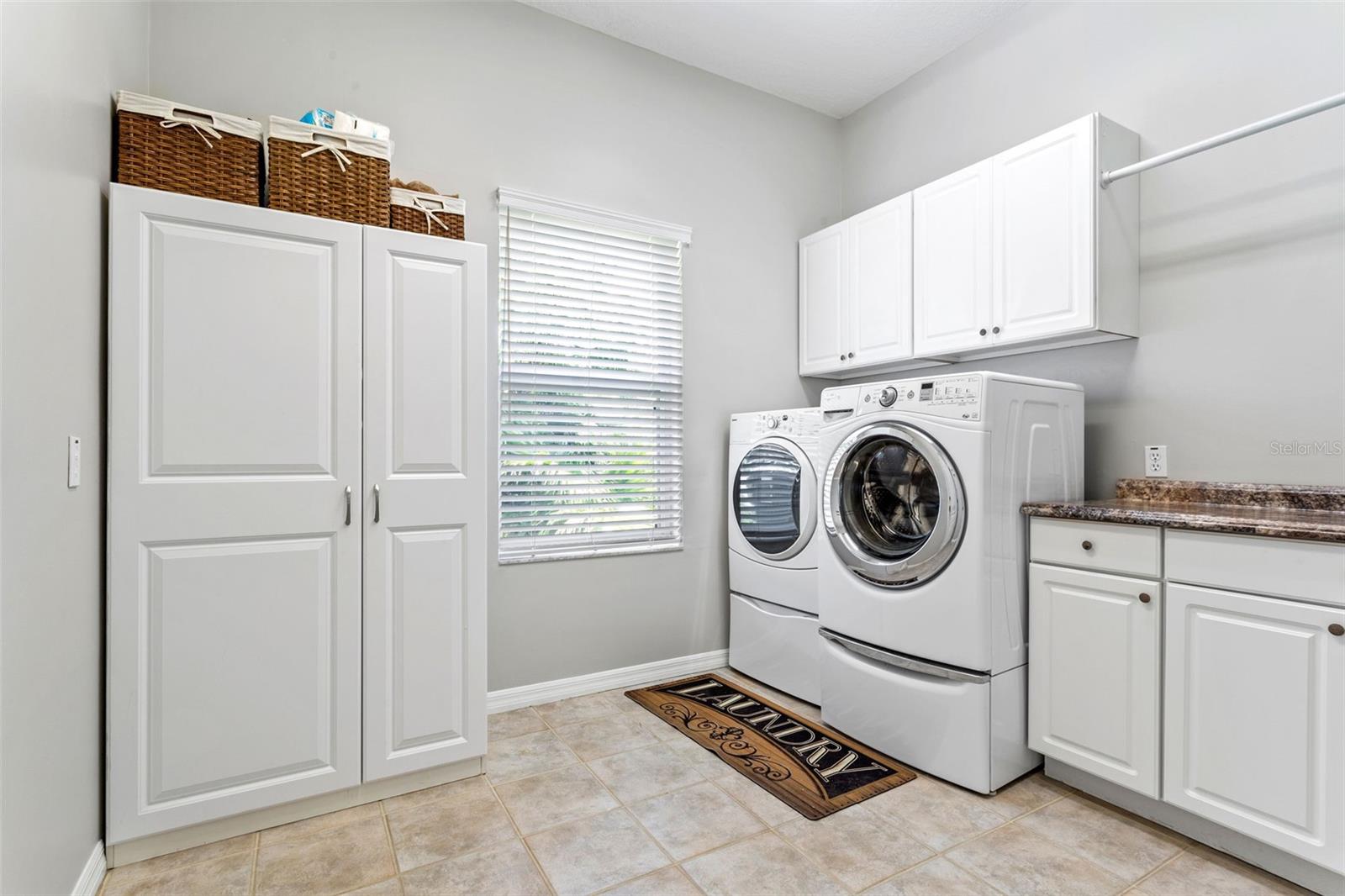 Spacious laundry room adjacent to kitchen