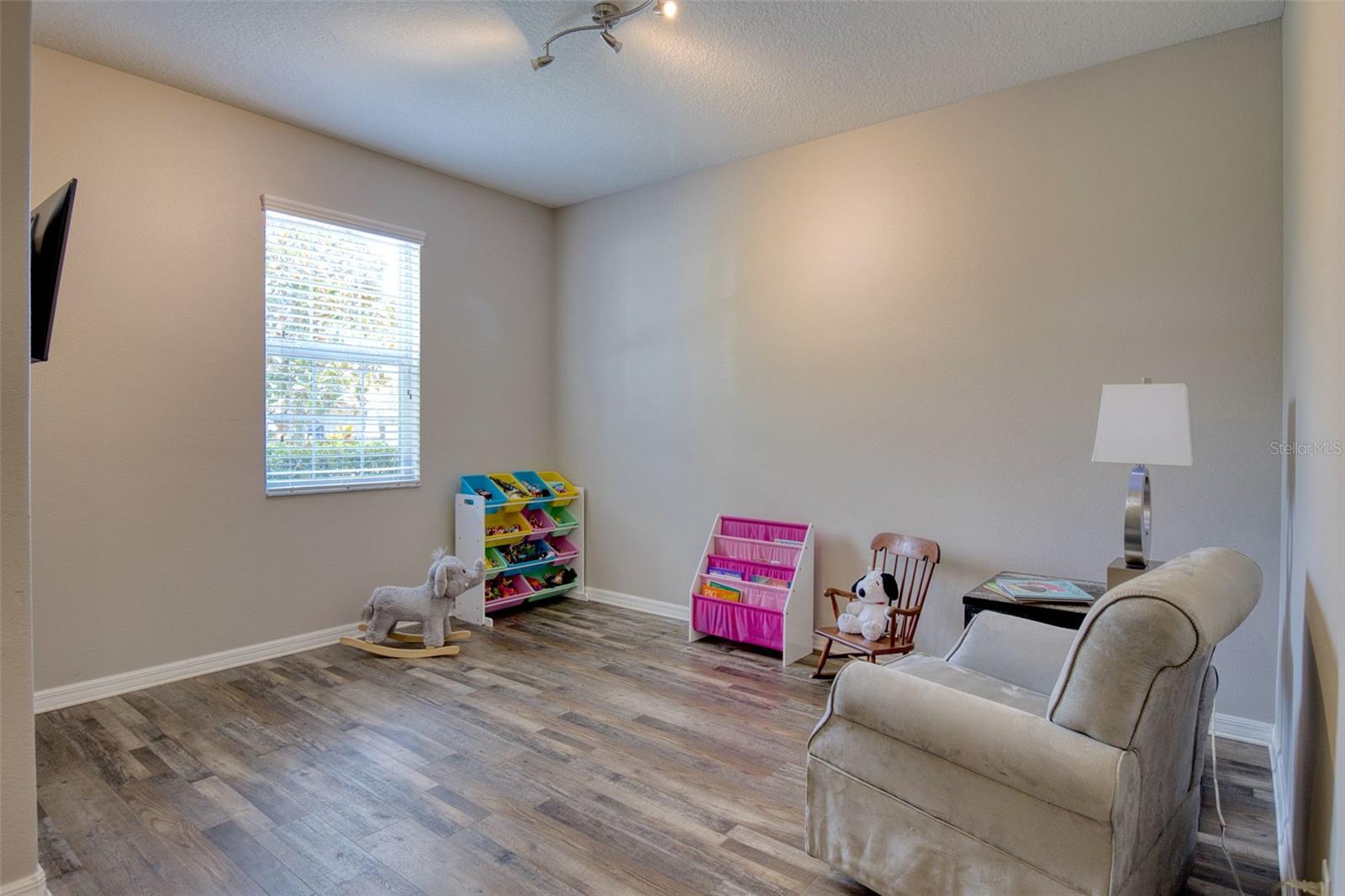 The space is filled with natural light and is currently used as the Reading area.