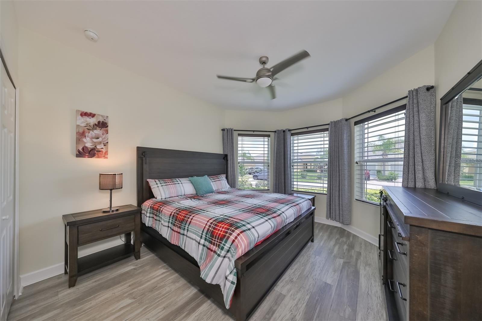 Bedroom #2 also has engineered flooring, large windows and a custom ceiling fan.