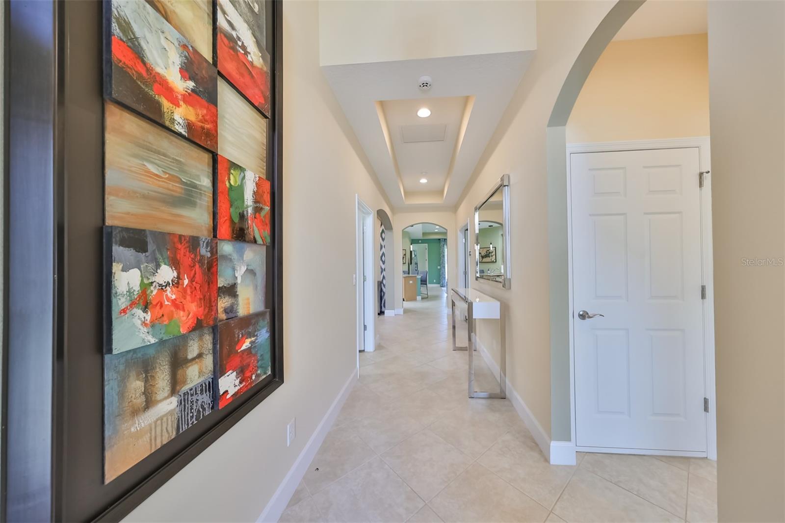 The entry way is bright, open and spacious with high ceilings and arched doorways.