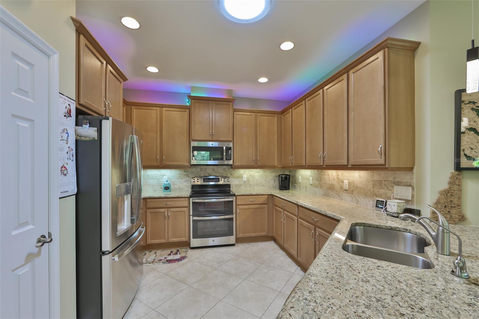 A contemporary kitchen, large pantry and unique custom lighting above the cabinets. You choose the colors that speak to you!